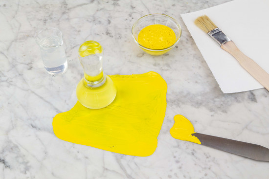 Grind pigment and binding medium with a muller until a soft paste is achieved. If you grind the pigments only with Polyvinyl Alcohol without additional water, it should be possible to achieve a thick, viscous paint with a good long-term stability.