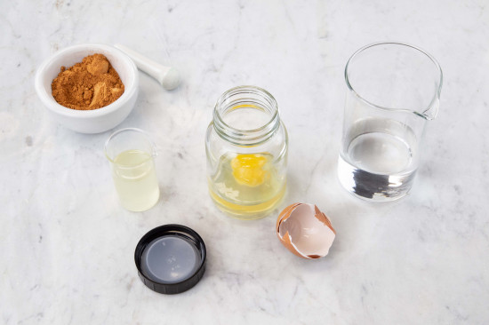 Crack a fresh egg into a glass with a screw cap.