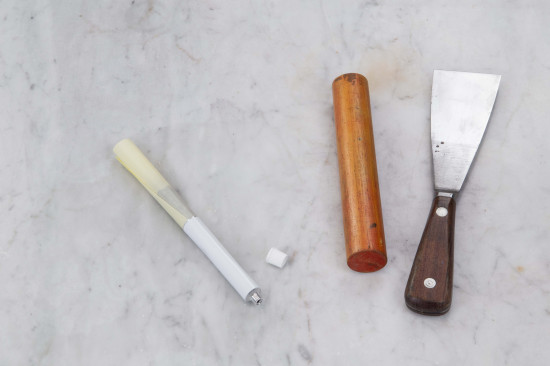 Roll it up like a self-made cigarette. The paper roll should be small enough to fit into the back of the tube. Push the paper with the oil paint into the tube and lay it onto a board.